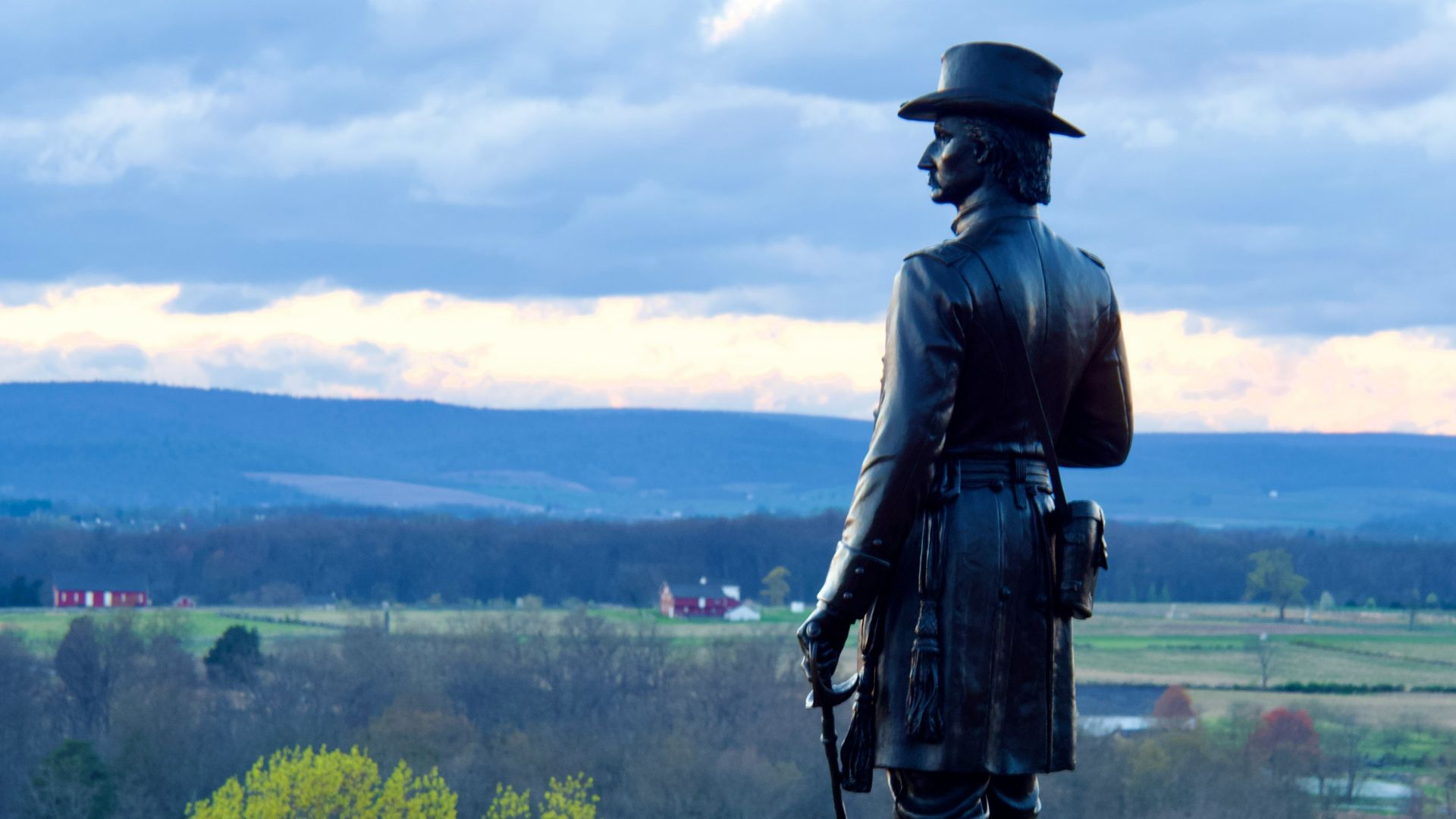 a statue of a man with a hat and a cane