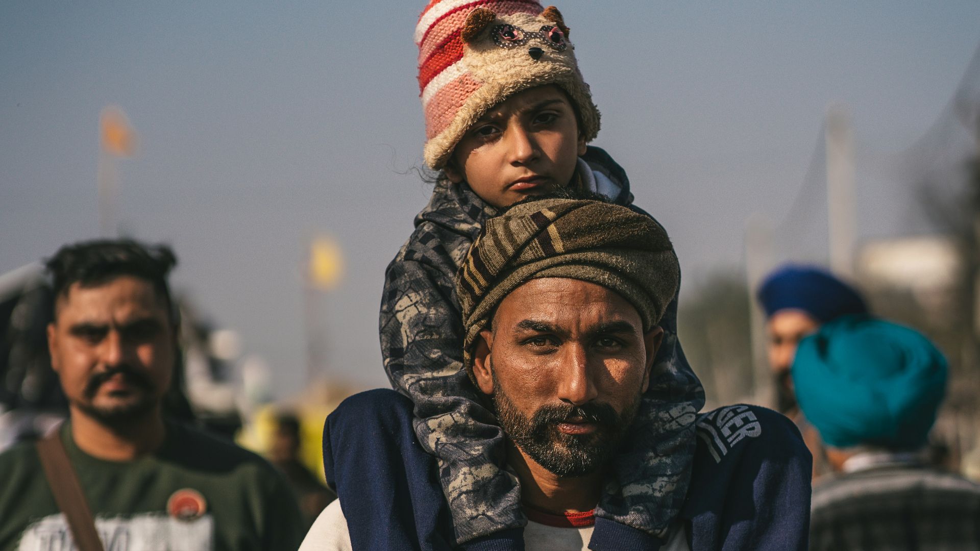 a man carrying a child on his shoulders
