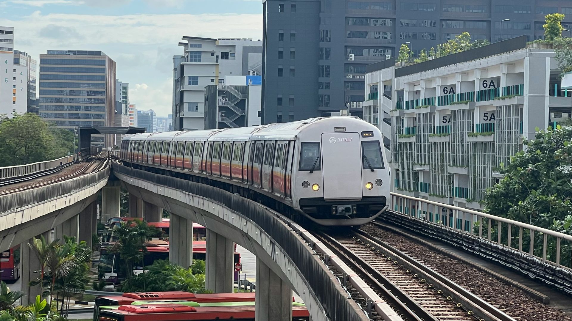 A train is going down the tracks in a city
