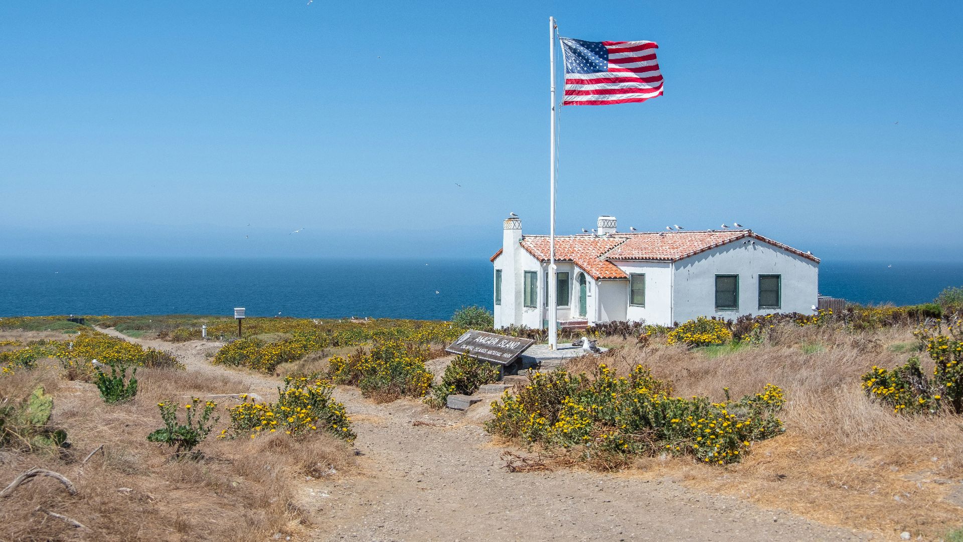 white concrete house near body of water during daytime