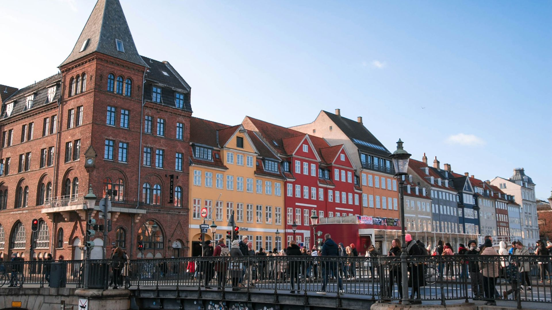 people walking on bridge near buildings during daytime