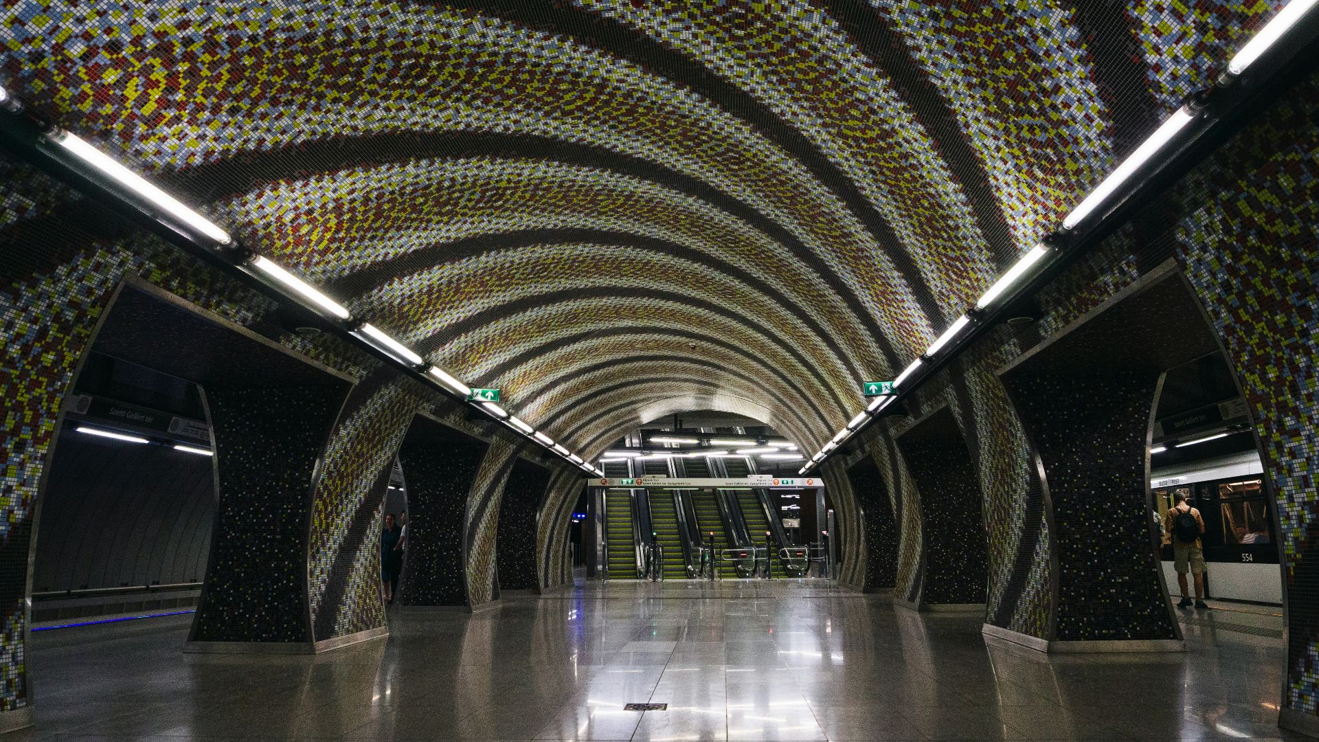 a very long tunnel with a lot of dots on the ceiling
