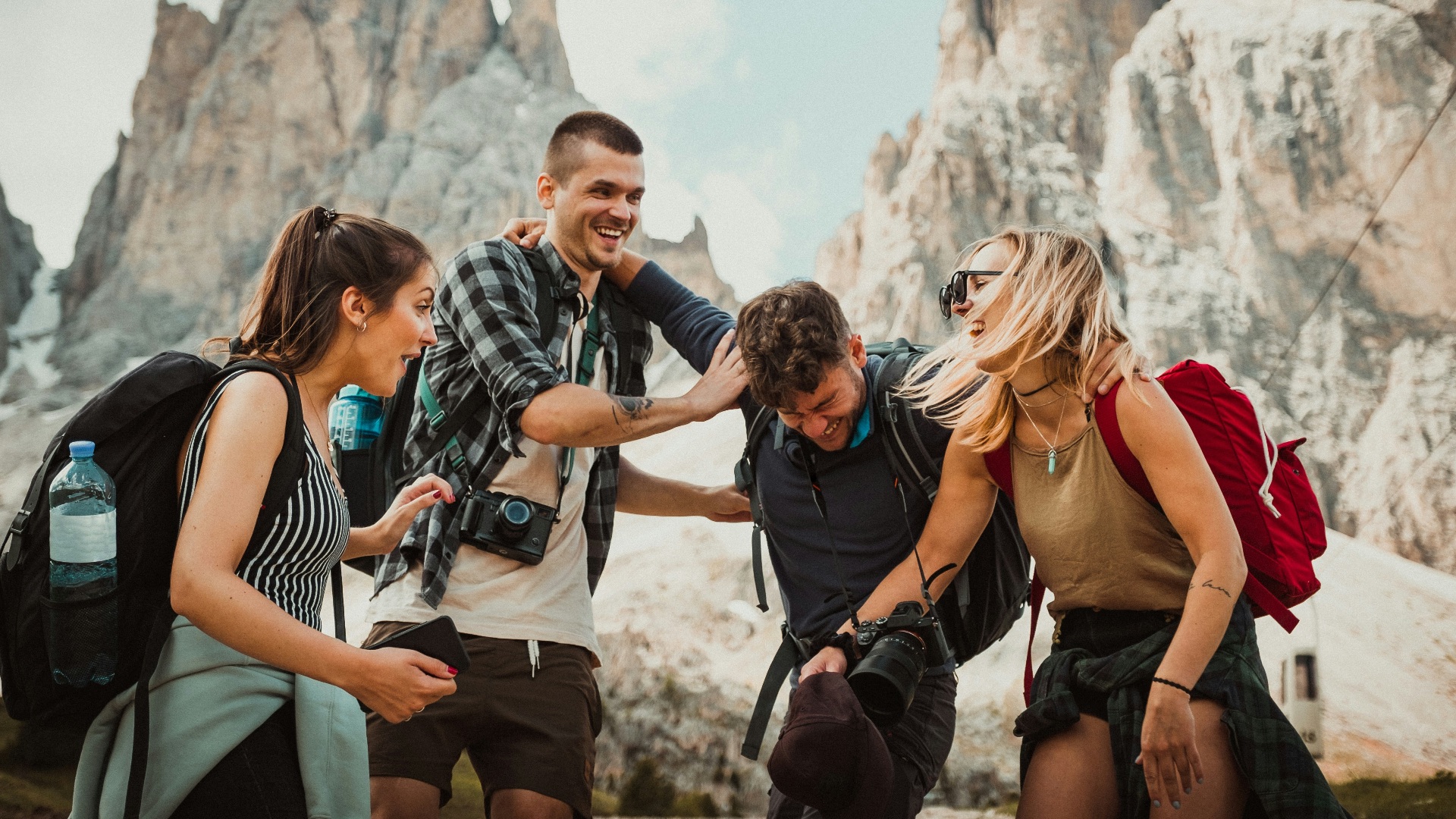 low-angle photography of two men playing beside two women