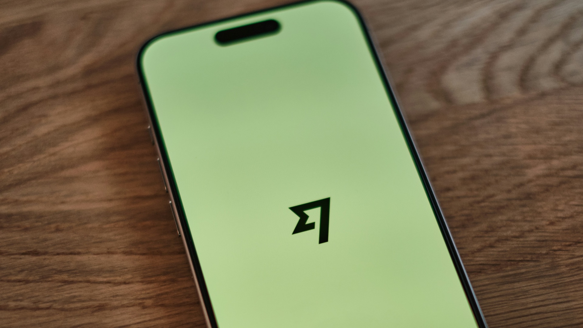 A cell phone sitting on top of a wooden table