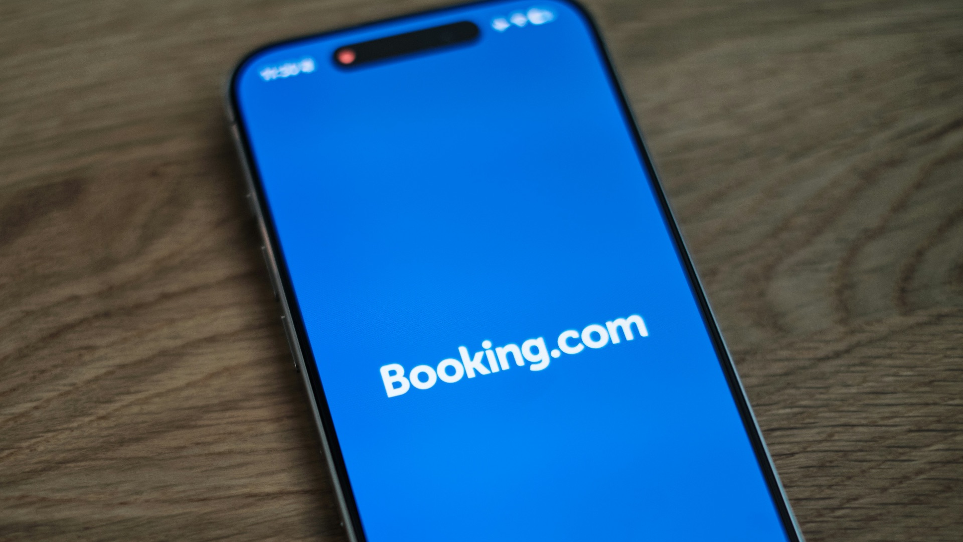 A blue samsung phone with the logo of bookking com on it