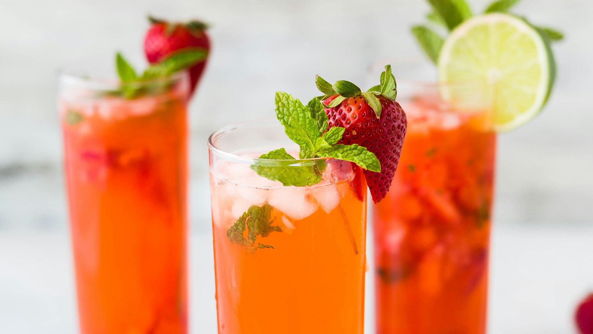 three clear drinking glasses filled with juice