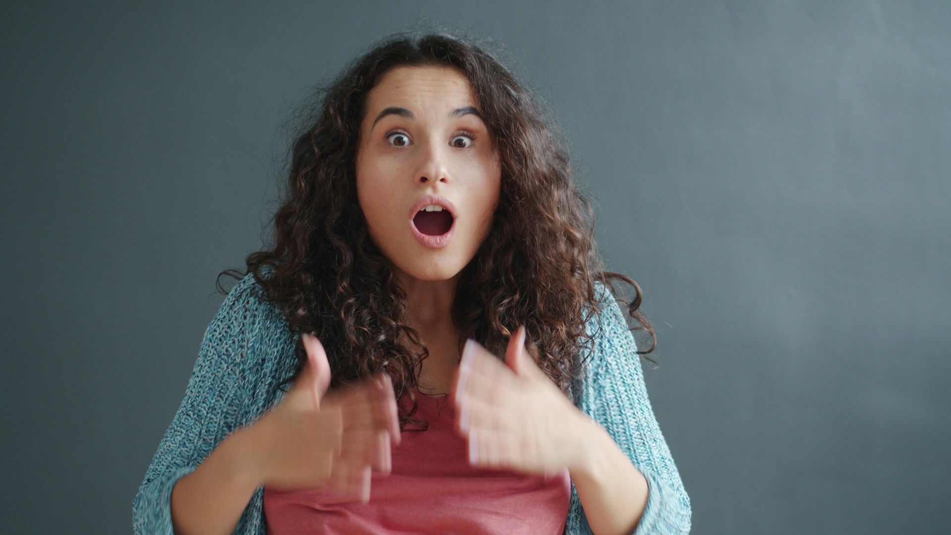 Young woman with surprised expression and open mouth.