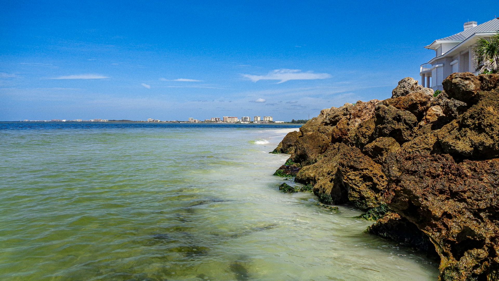 a view of the ocean from a rocky shore