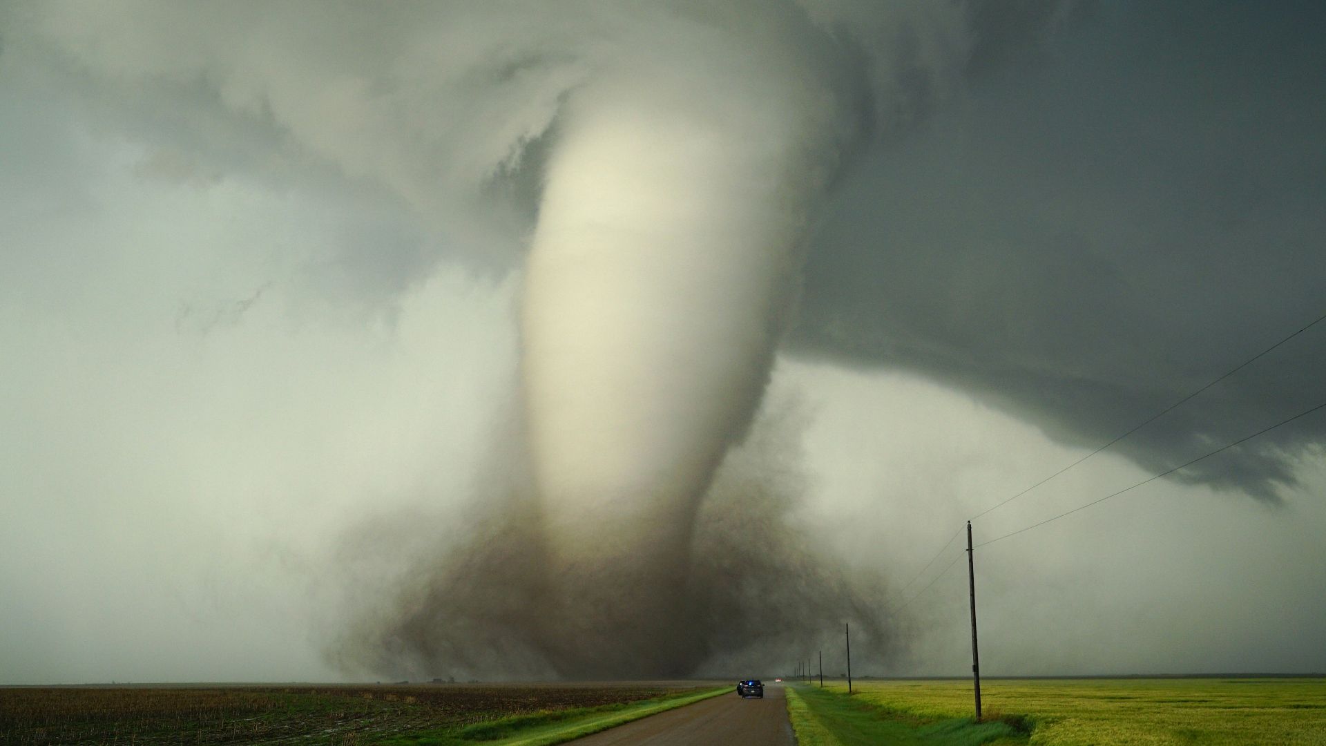 a large tornado is coming down the road