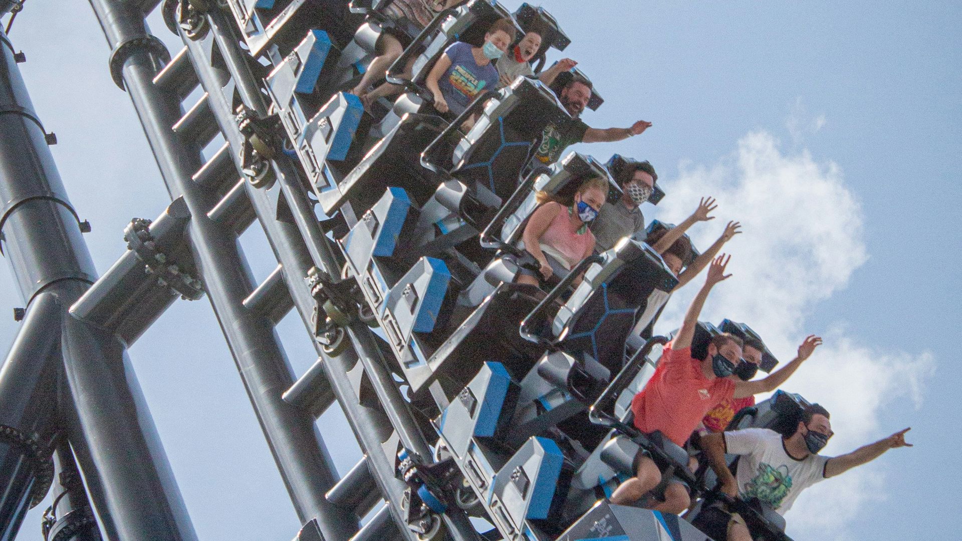 people riding on roller coaster during daytime
