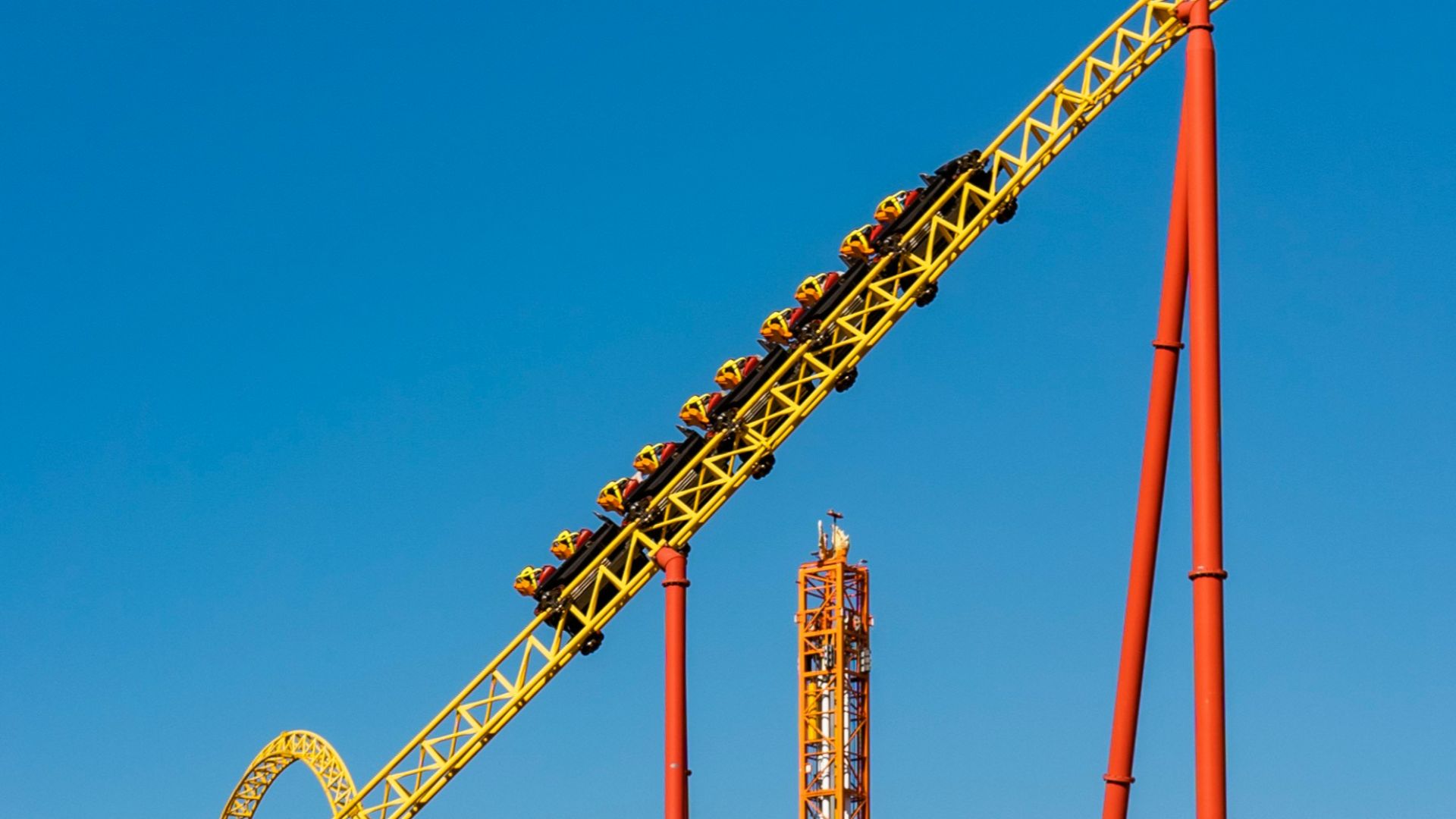a roller coaster in an amusement park on a clear day