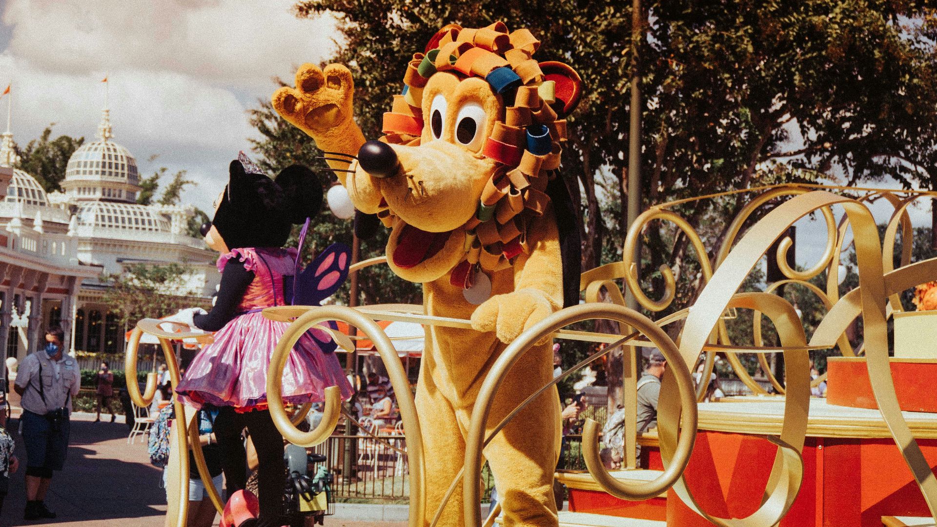 brown bear mascot standing near people walking on street during daytime