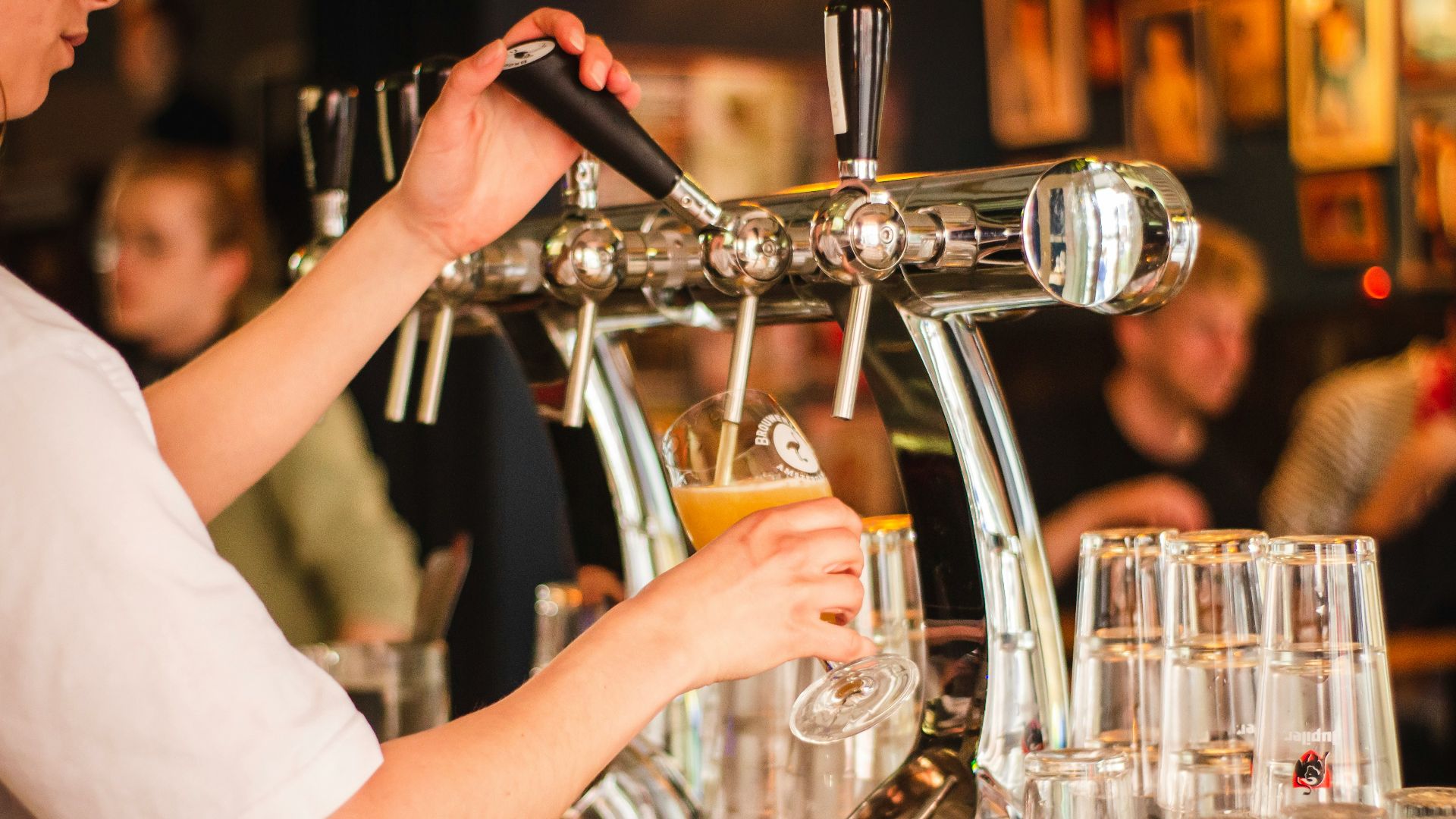 person holding handle of faucet