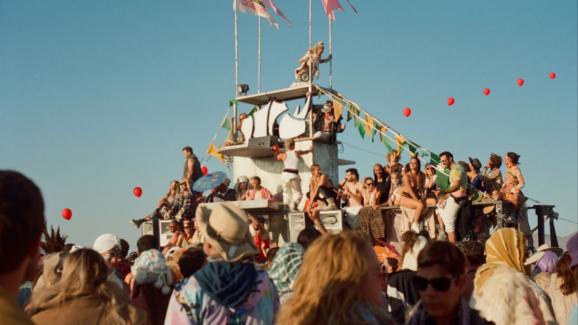 a crowd of people standing on top of a boat