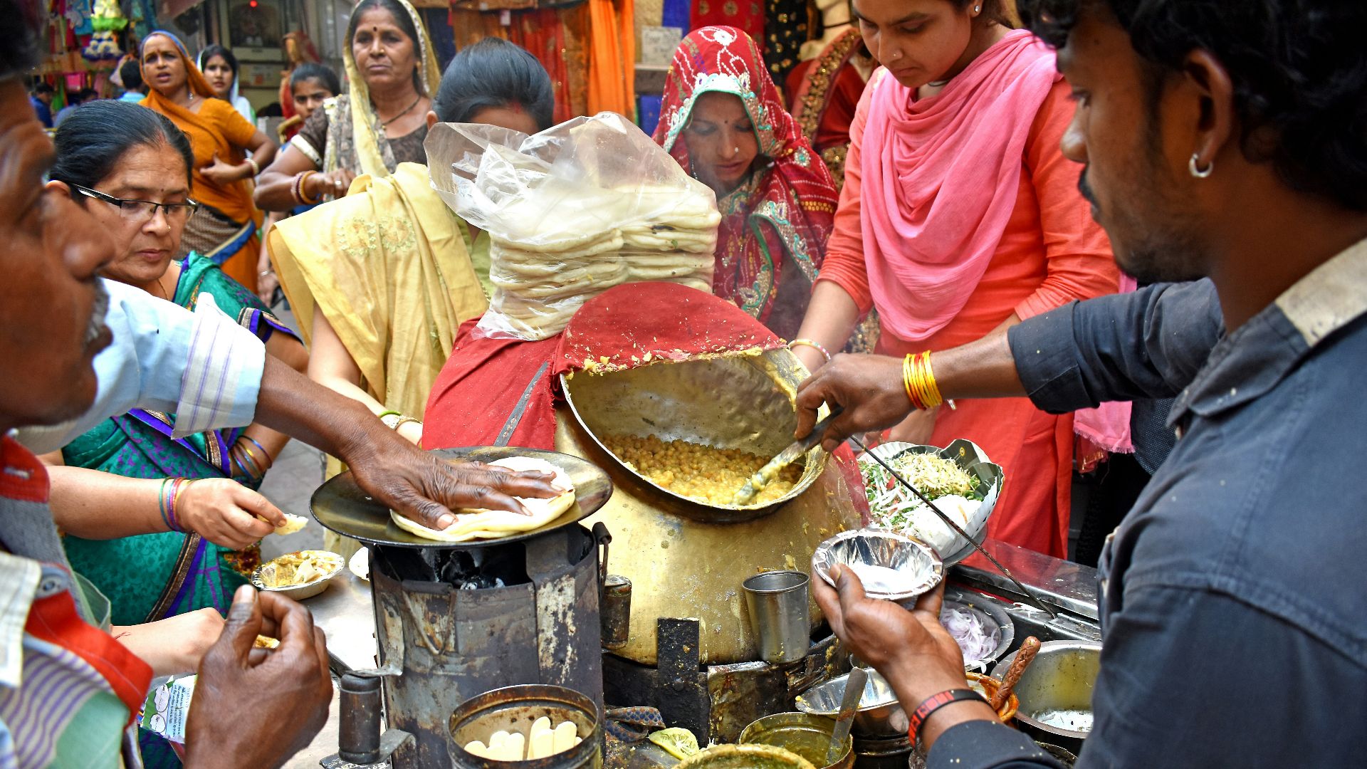 a group of people cooking in a kitchen