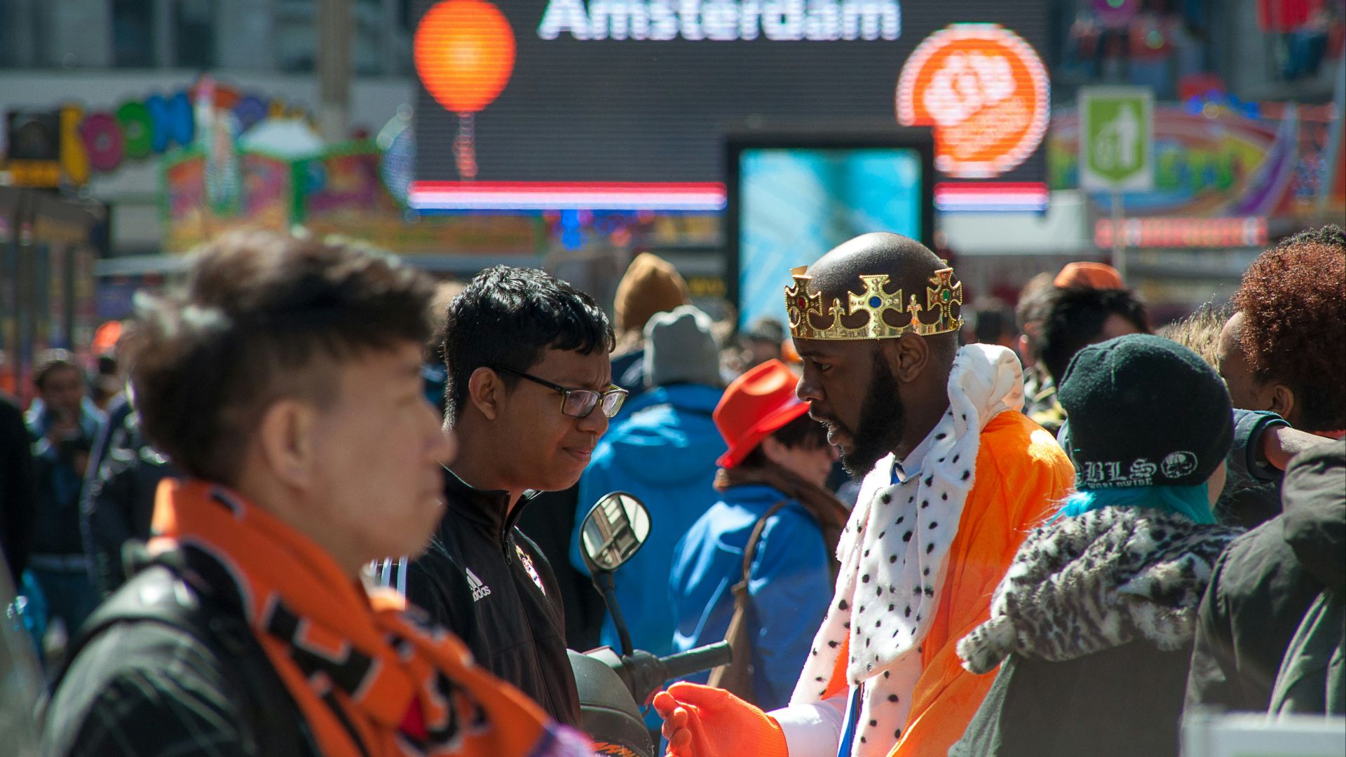 a crowd of people standing around each other