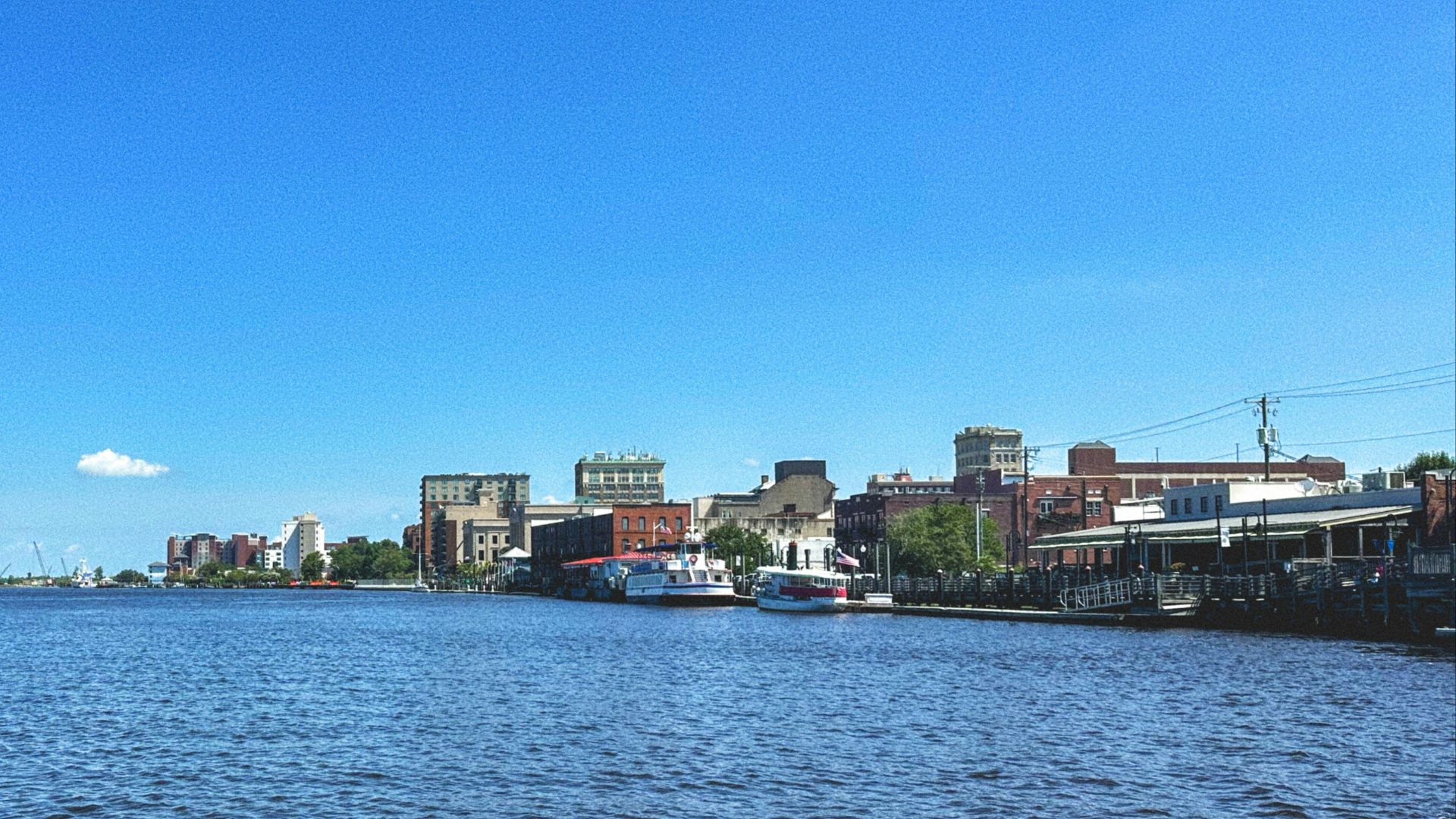 A body of water with a city in the background