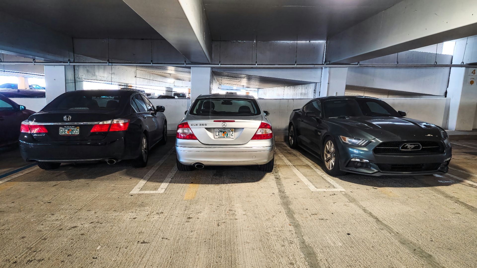 A group of cars parked in a parking garage