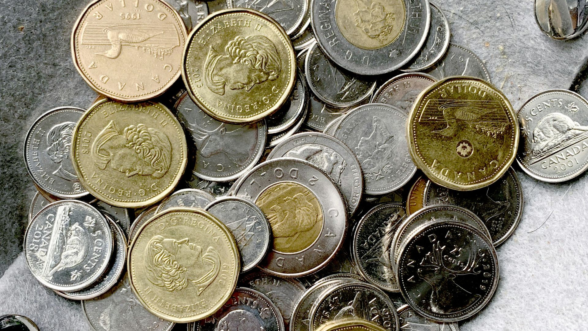 gold and silver round coins on gray surface