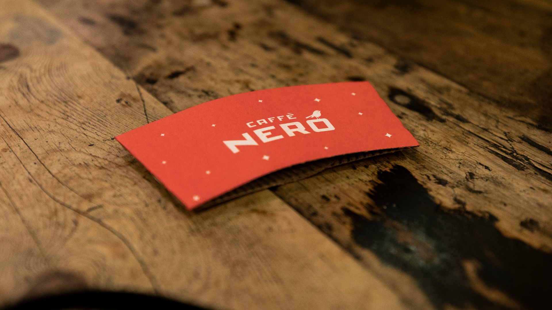 red and white love print card on brown wooden table