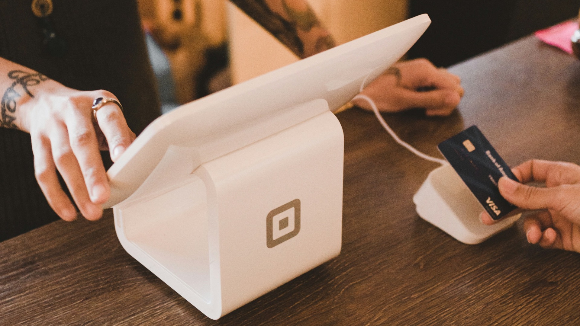 person holding white POS machine