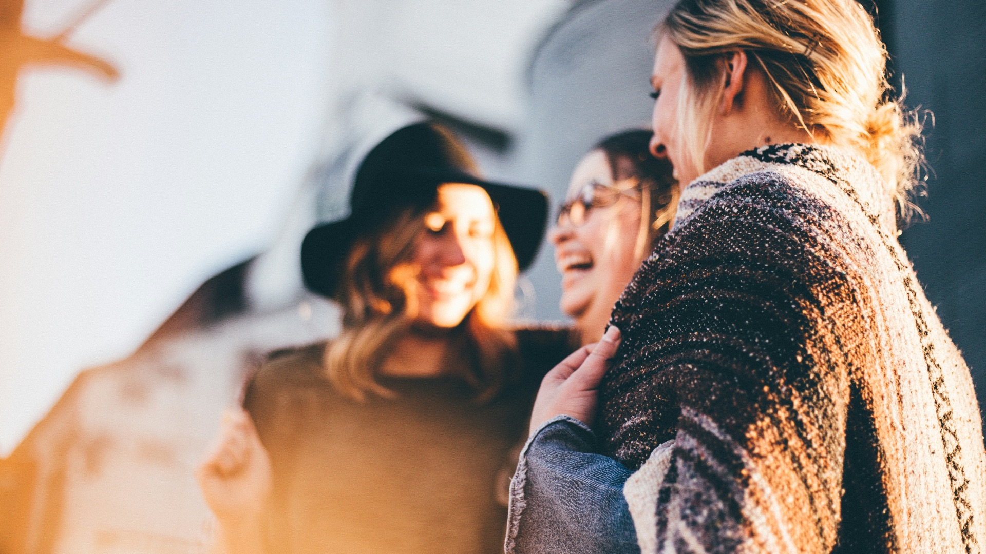 people laughing and talking outside during daytime