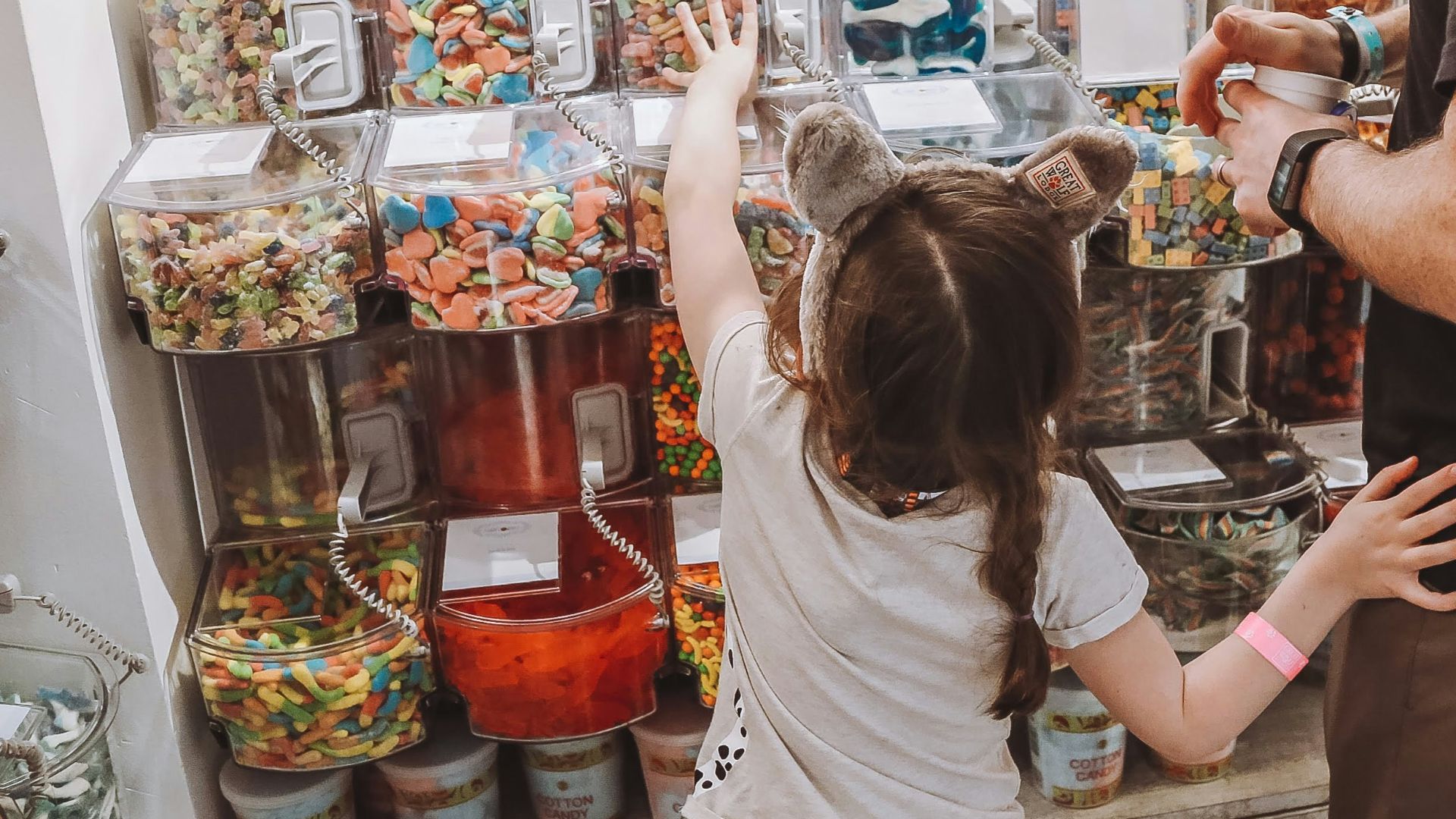 a man and a little girl standing in front of a store
