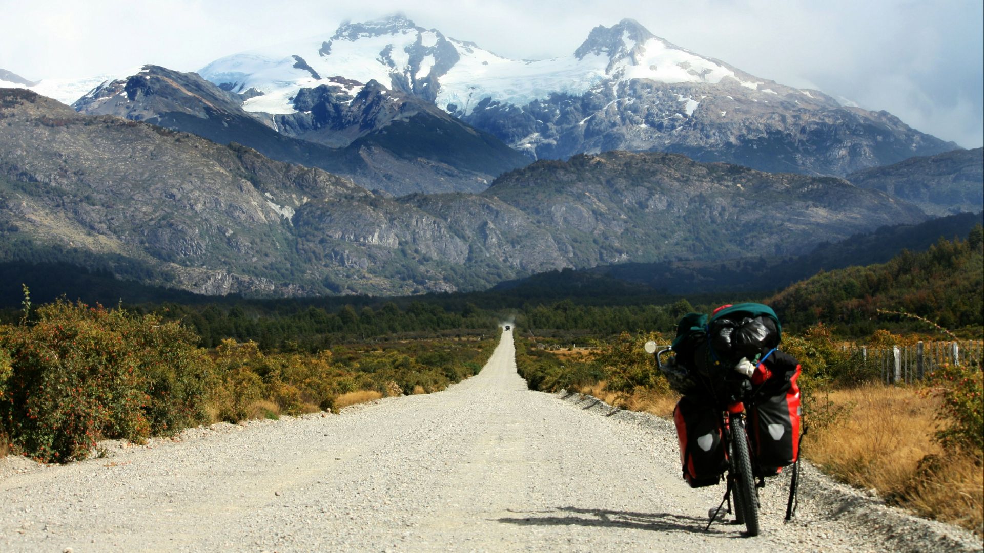black motorcycle parked at road toward glacier mountain photo during daytime