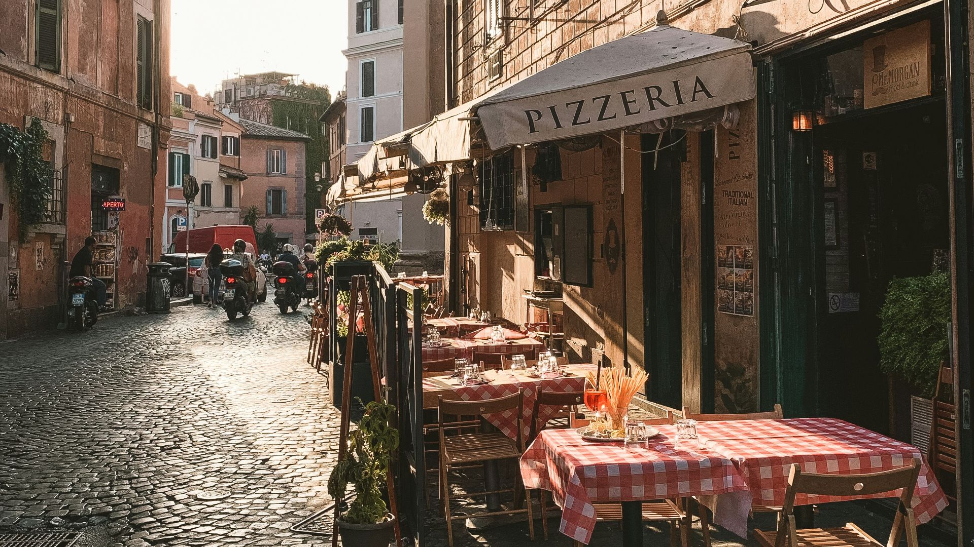 carriage and table on store front beside houses