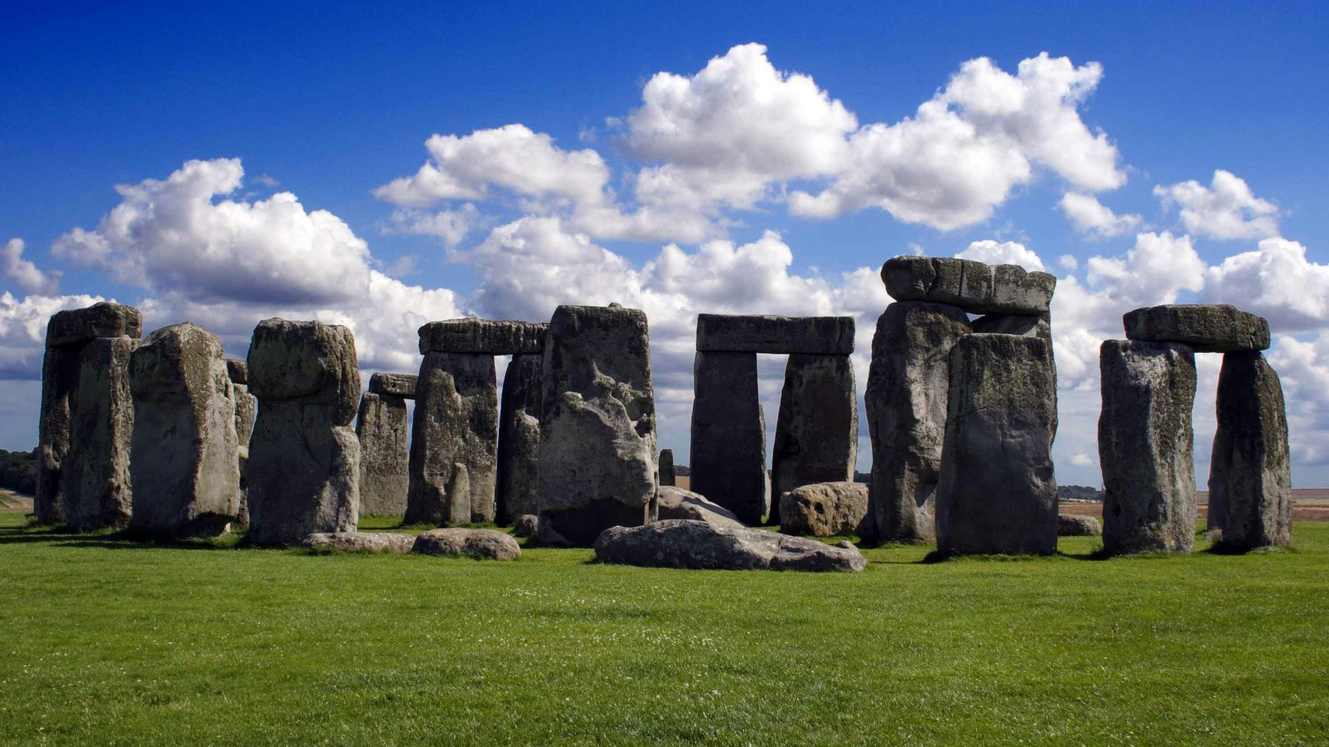 gray rock formation under white clouds and blue sky during daytime