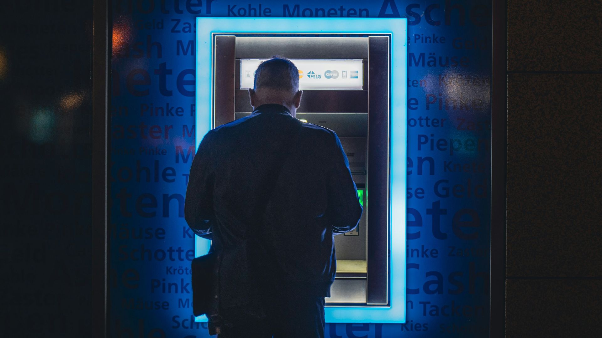 a man standing in front of an atm machine