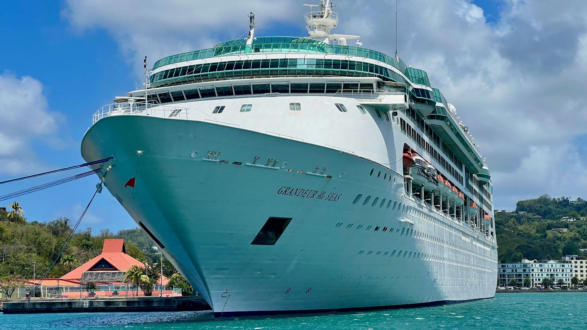 a cruise ship in the water near a dock