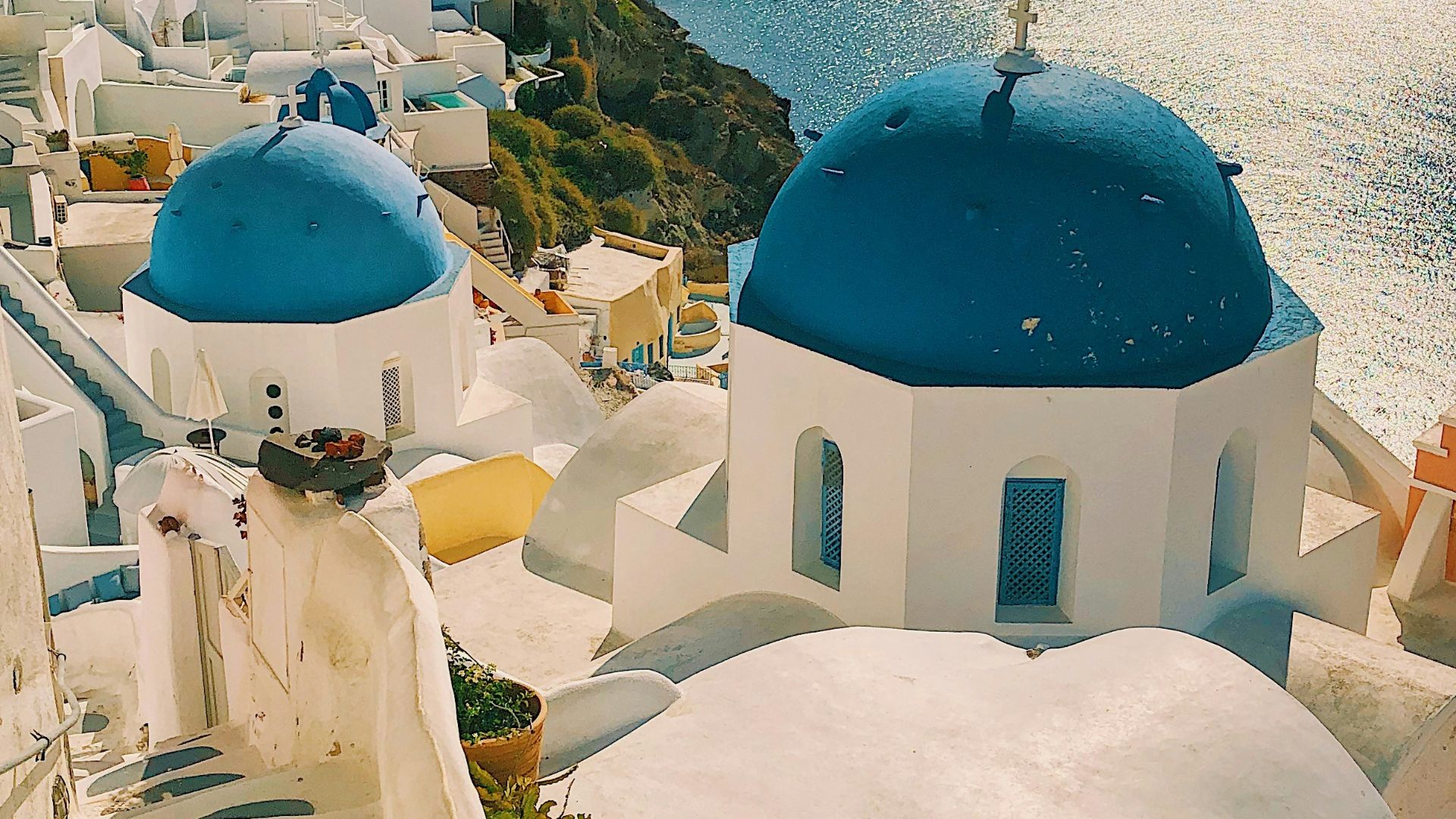 white and blue concrete building near body of water during daytime