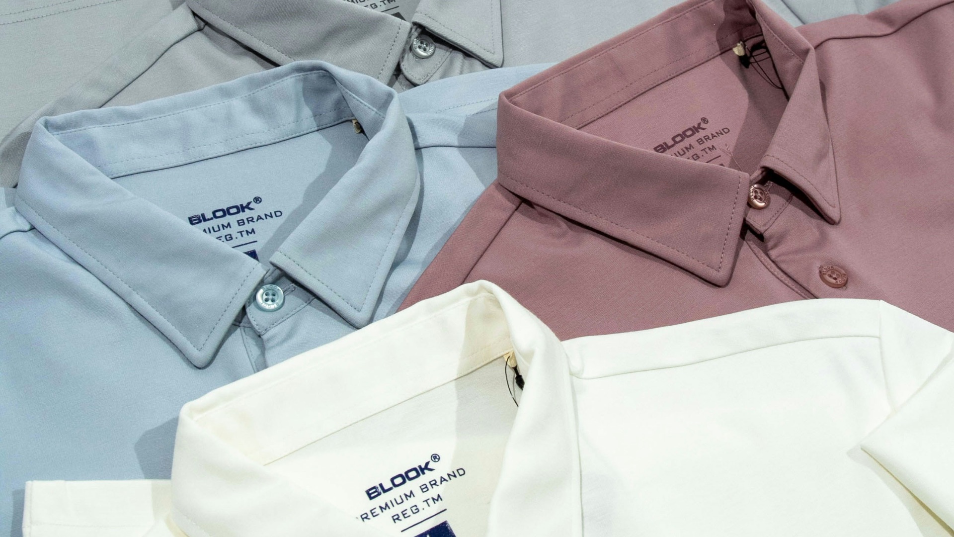 a group of four men's shirts sitting next to each other