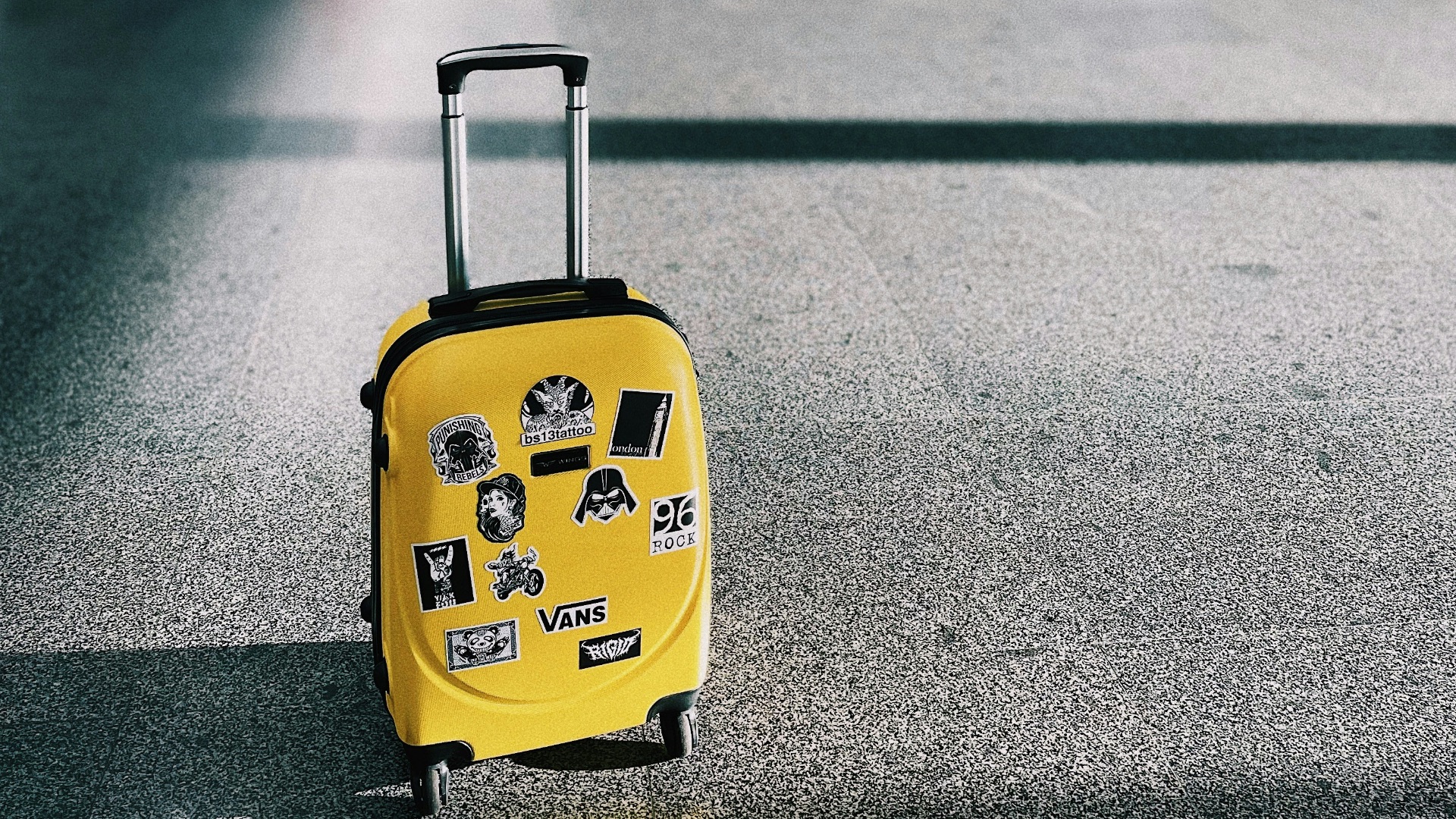 a yellow piece of luggage sitting on top of a floor