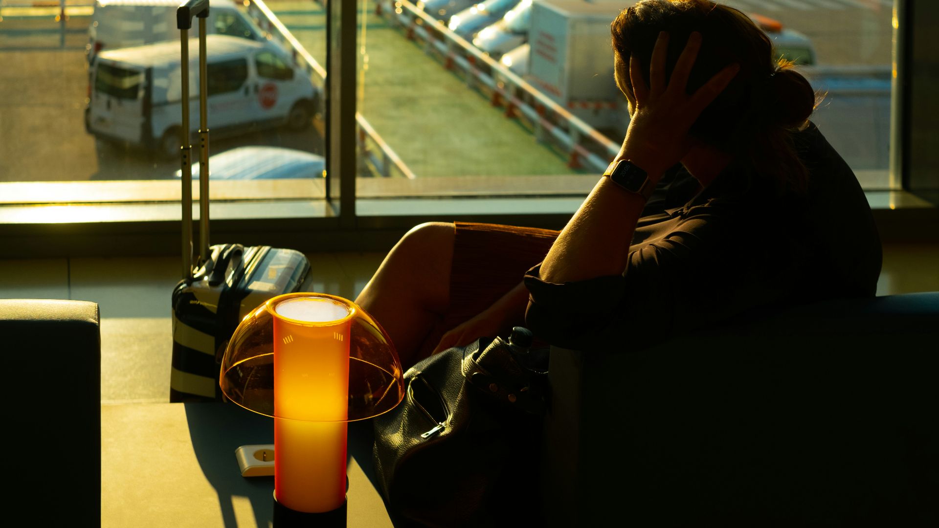 a person sitting on a couch in front of a window
