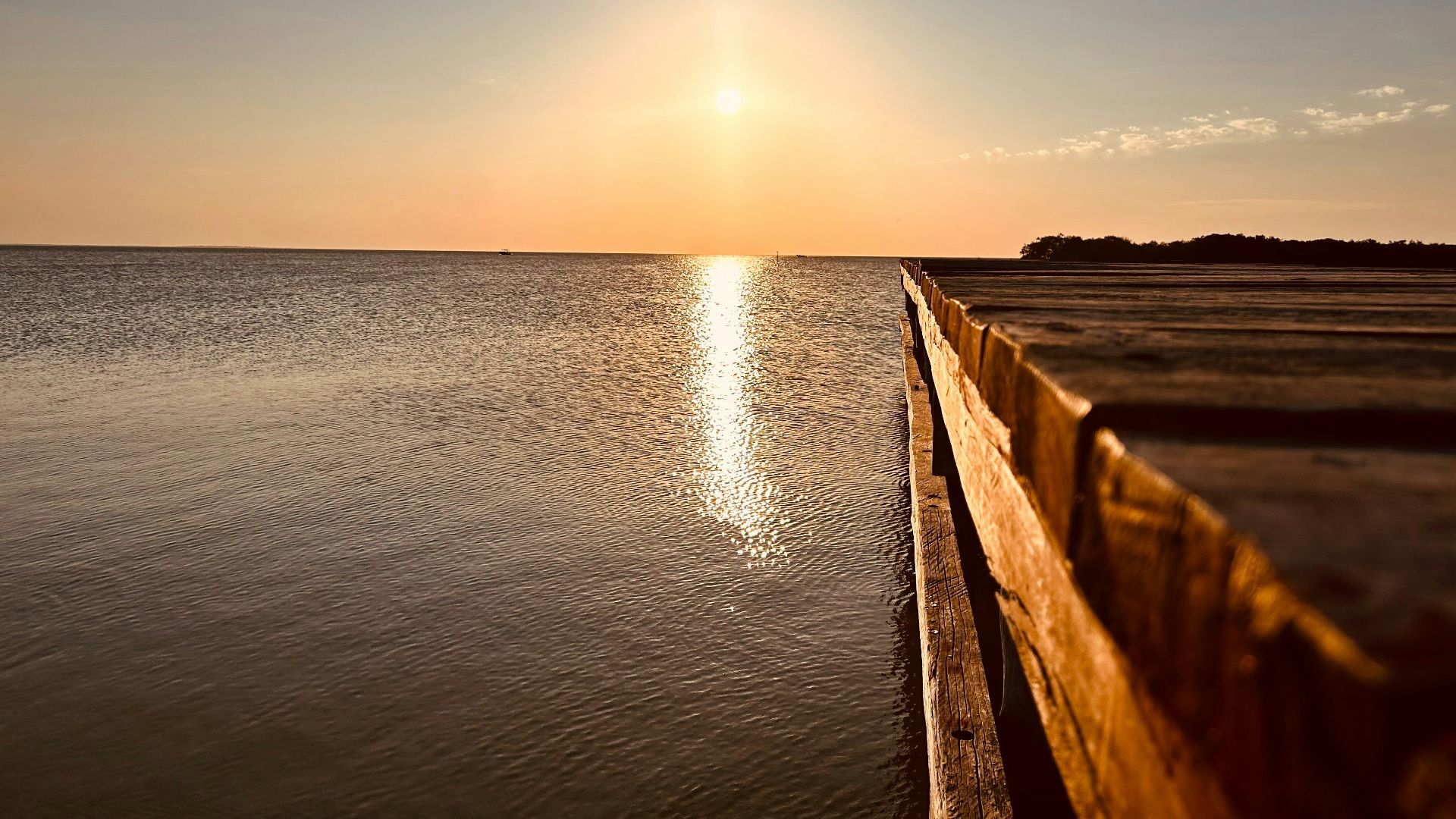 the sun is setting over a body of water