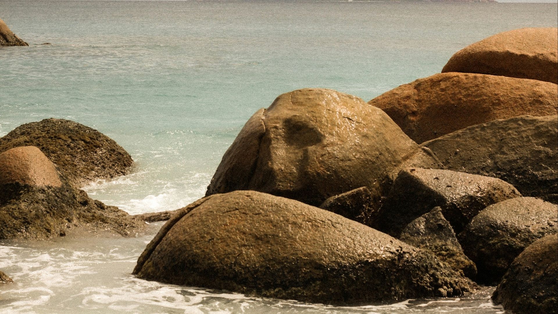 brown rock formation on sea during daytime
