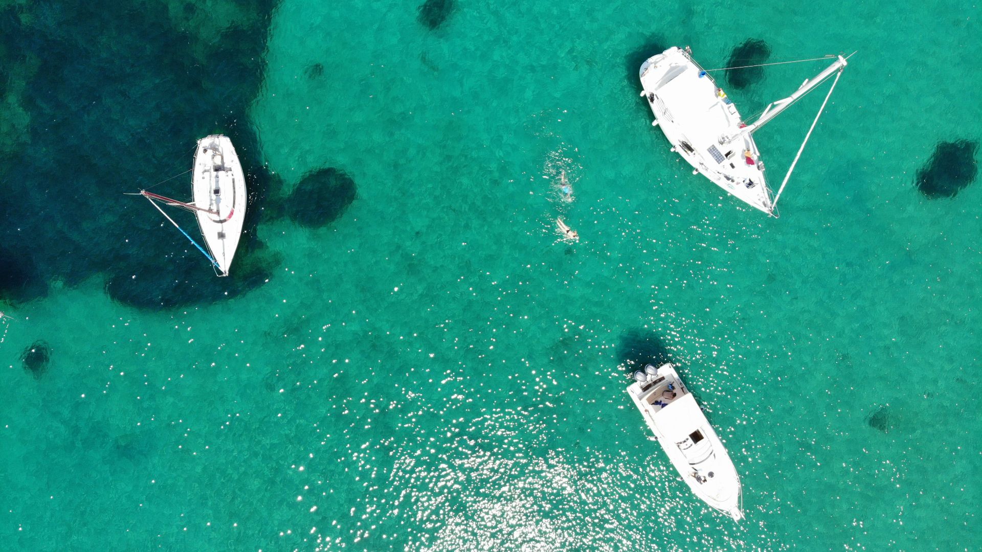 aerial view of three white boats on water