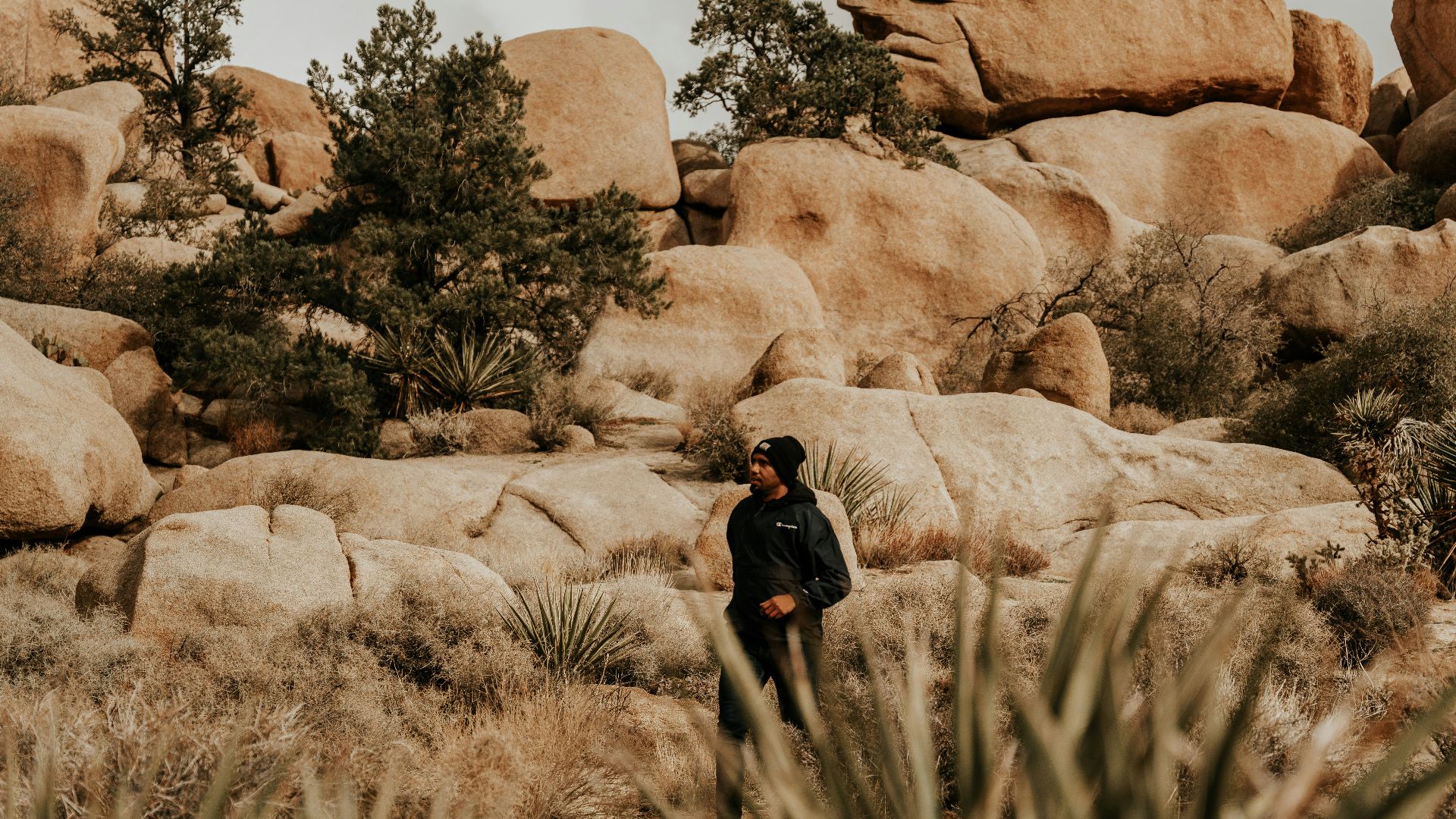 a man standing in the middle of a desert