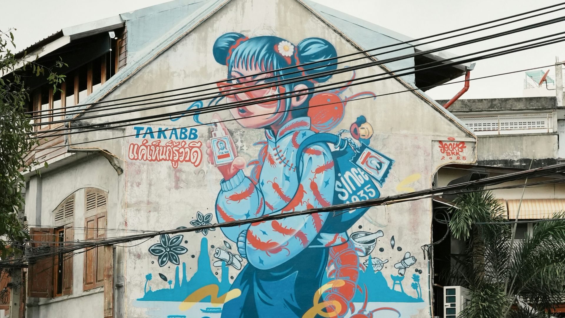 Colorful mural of a cartoon character on building wall.