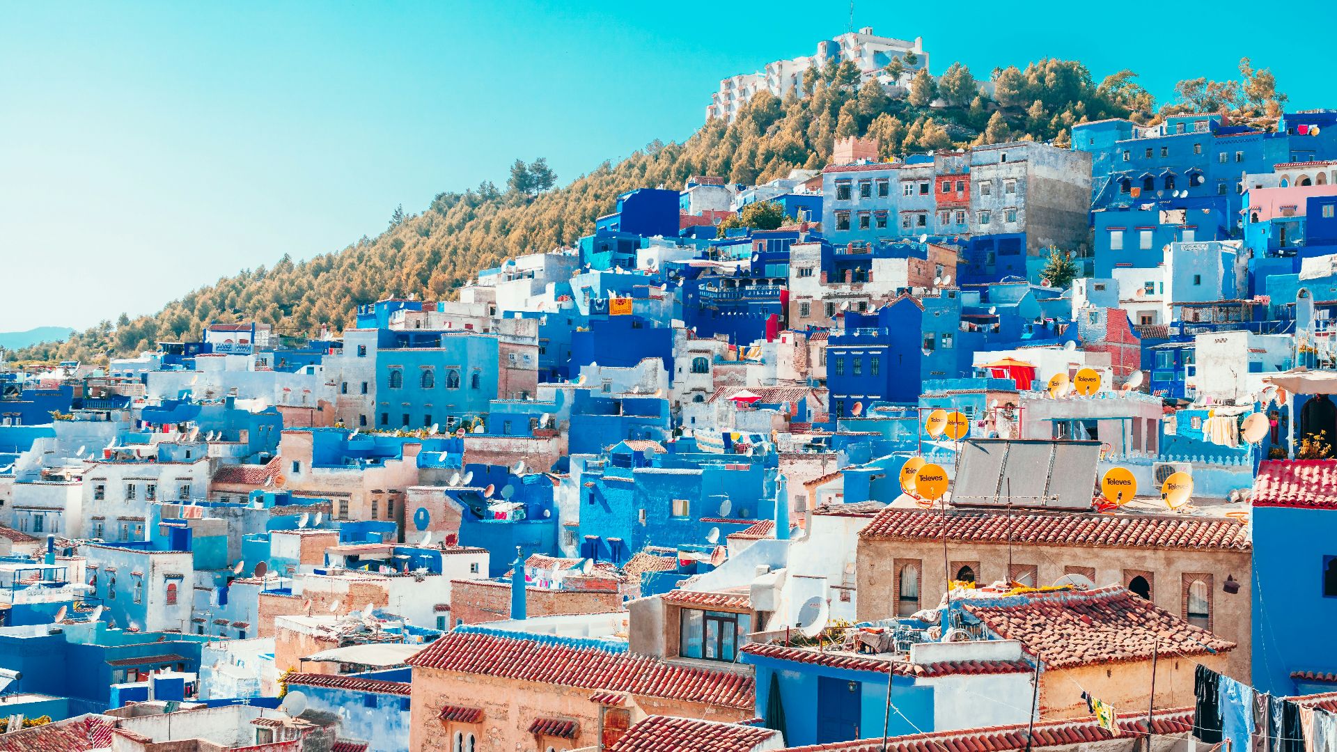 blue and white painted houses on the cliff