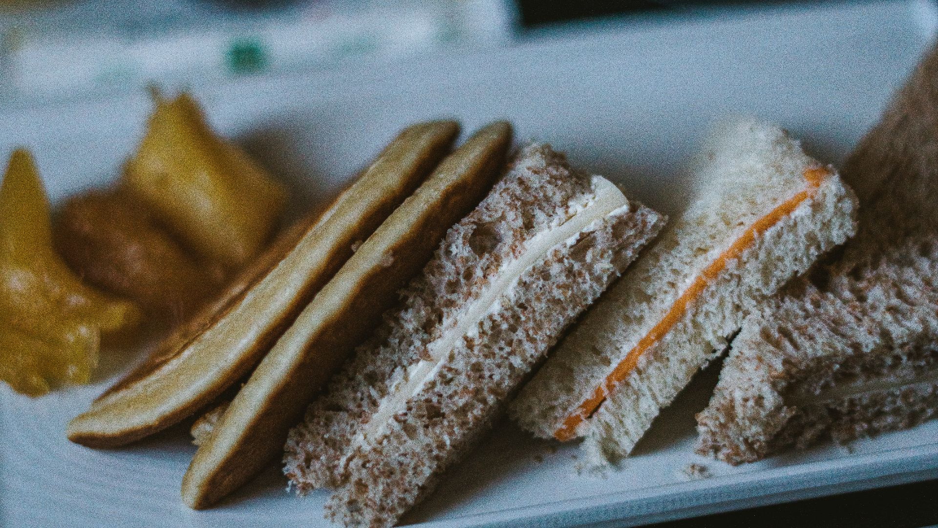 a white plate topped with sandwiches and pickles