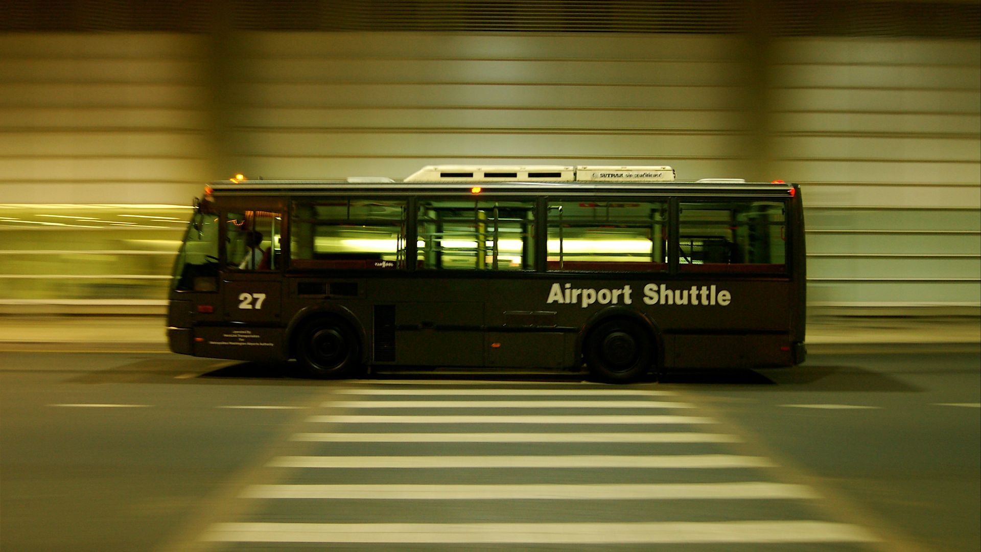 red and black bus on gray road