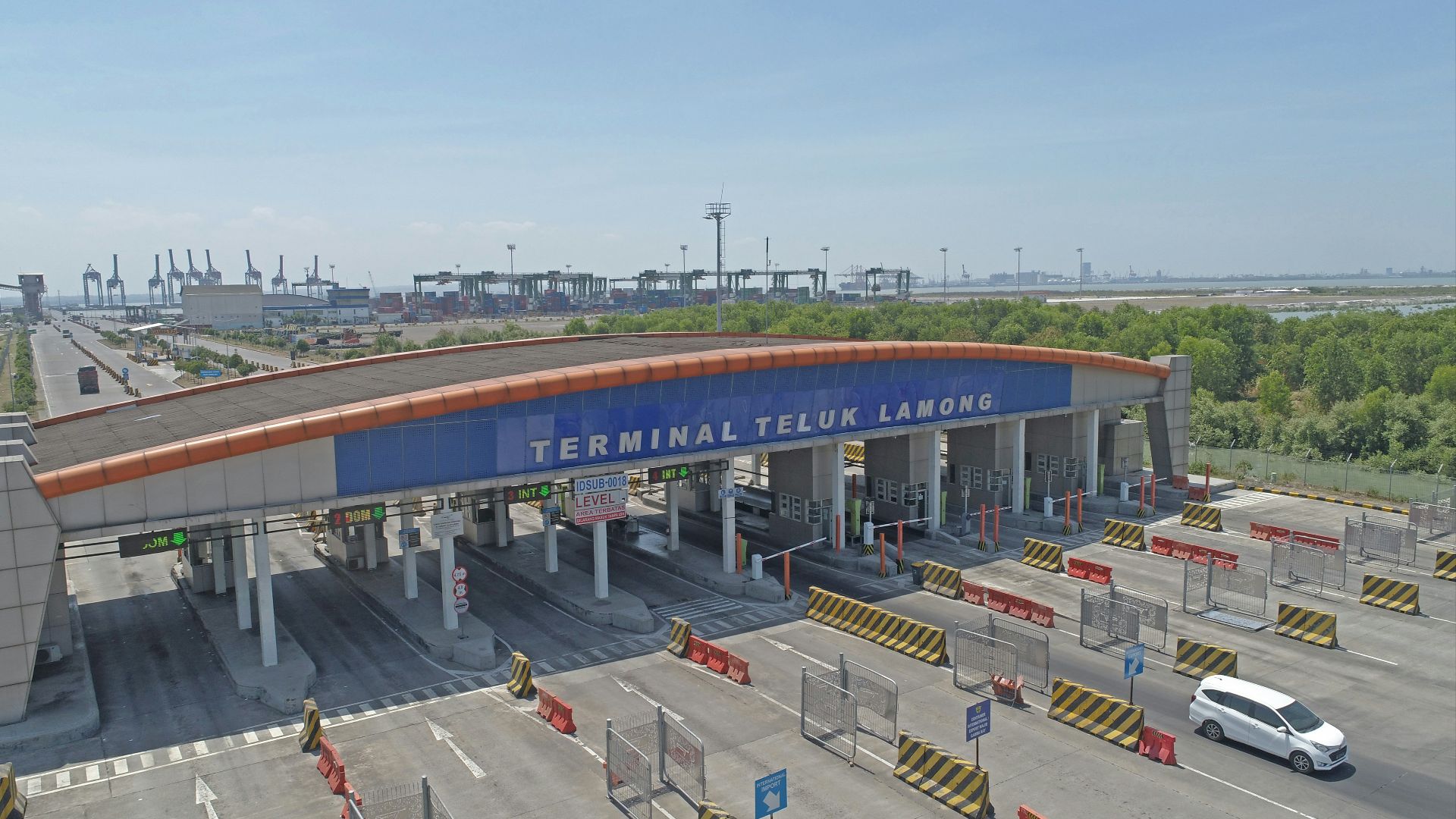 Terminal teluk lamong entrance with cars and cranes.