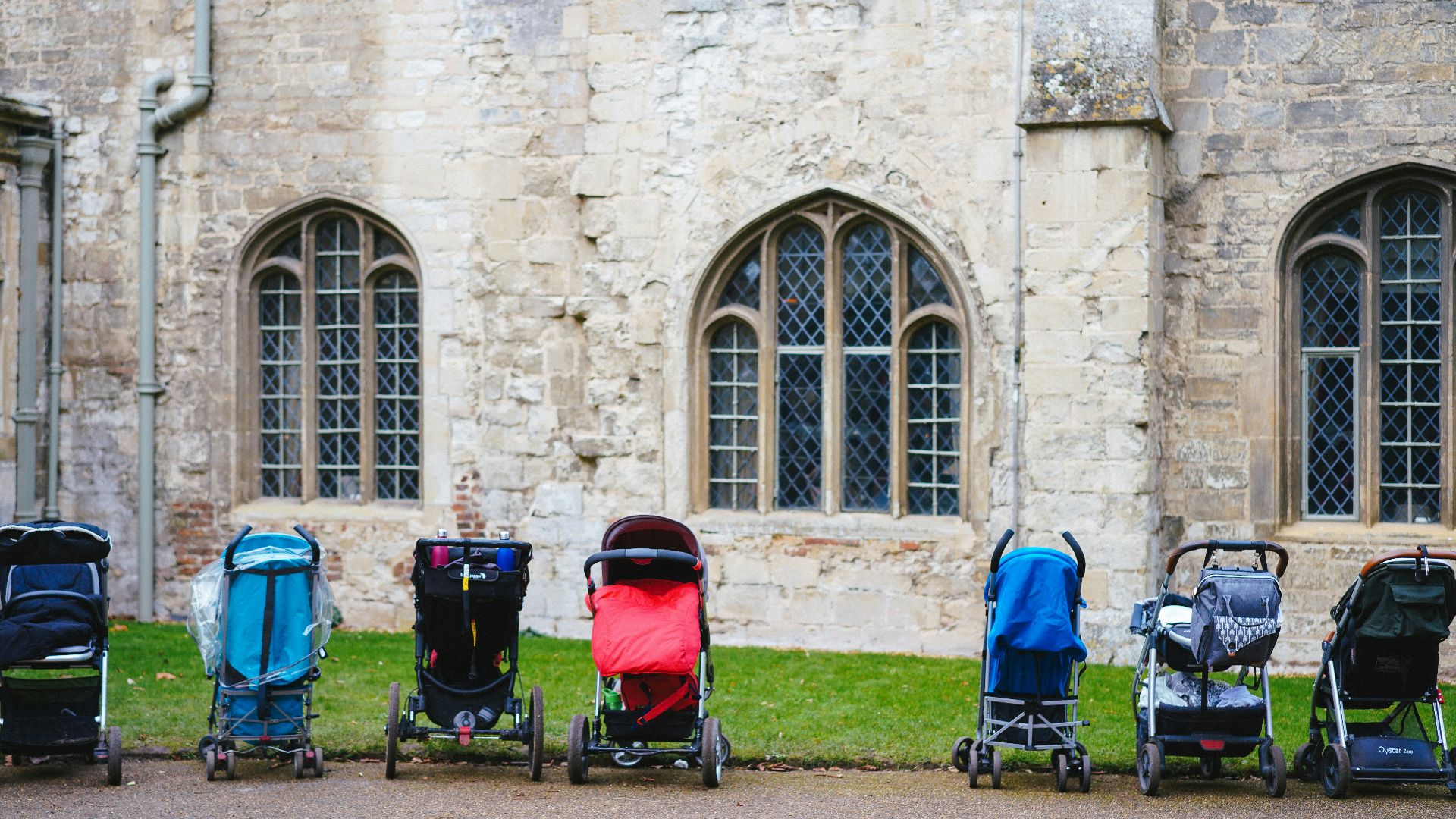 seven assorted-colored strollers near building