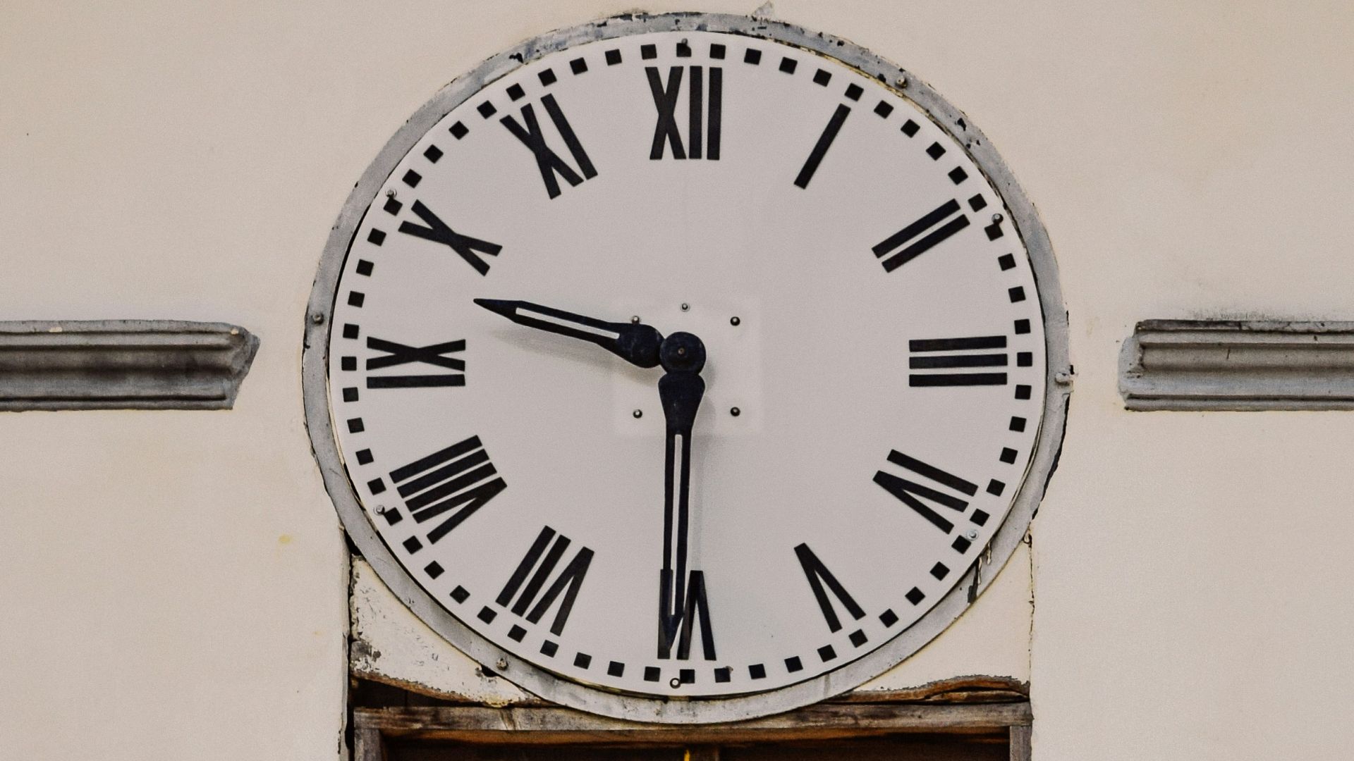 a large clock mounted to the side of a building