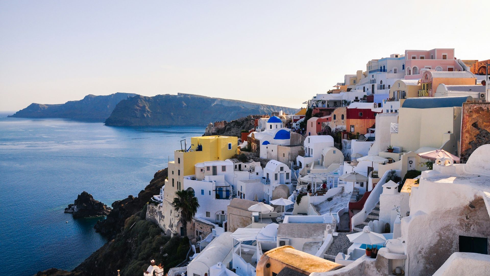 white and brown concrete houses near body of water during daytime