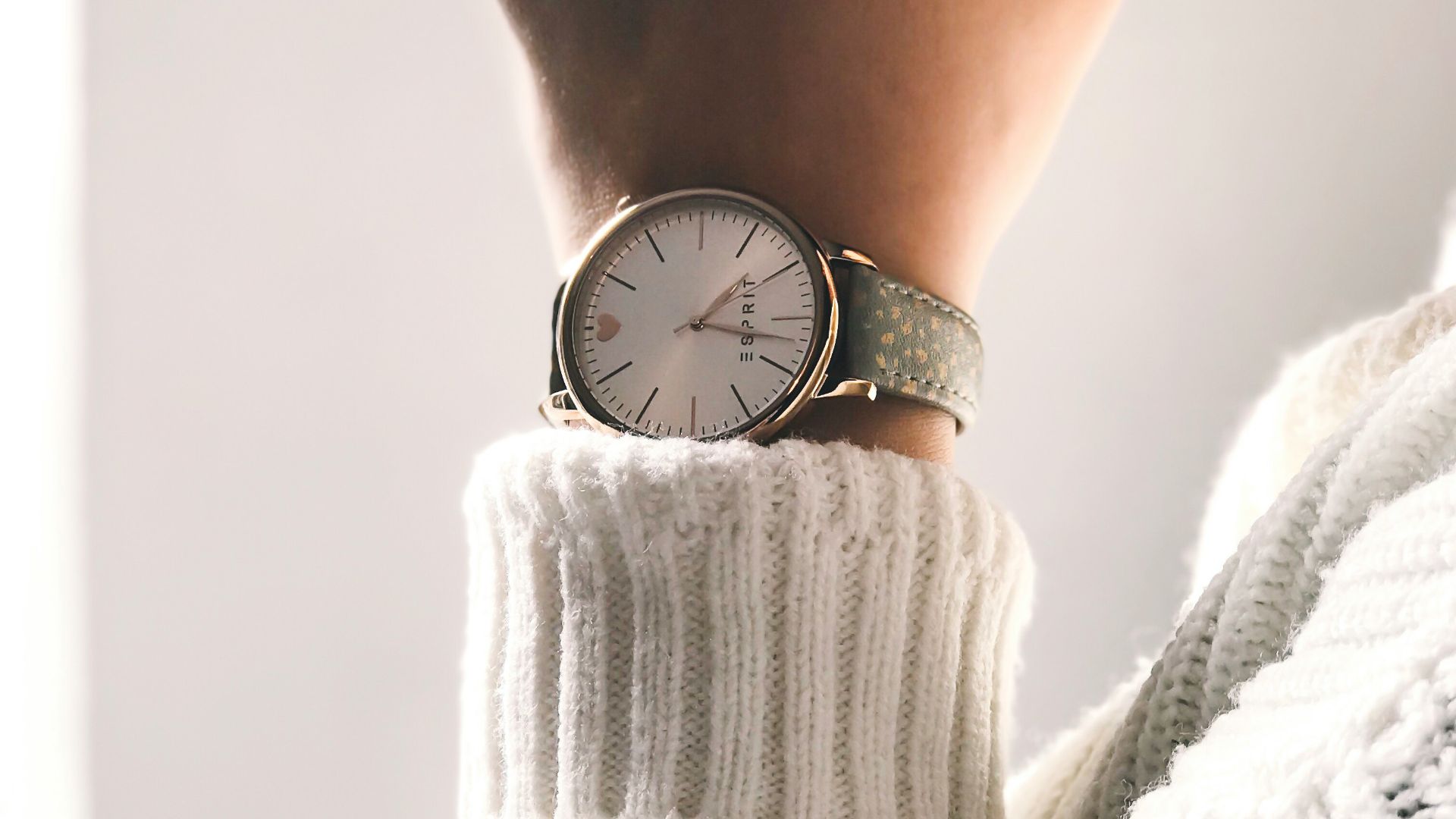 person wearing round silver-colored analog watch