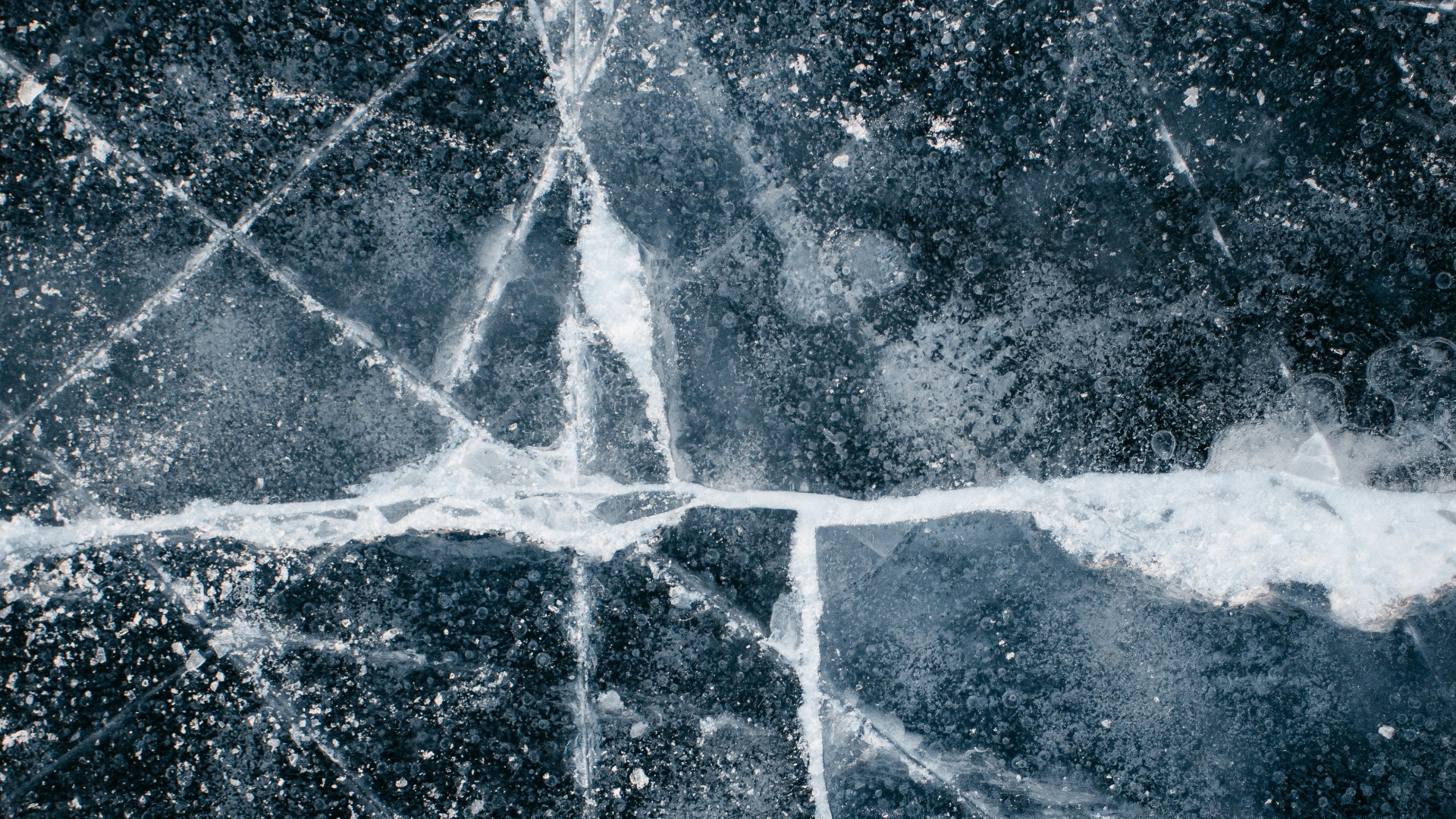 a black and white photo of a cross made of ice
